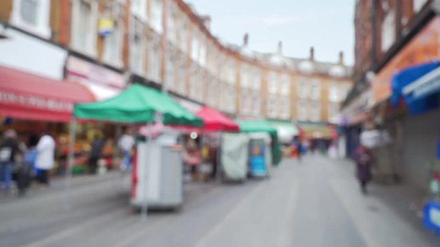 Scene of popular street market in Brixton, London, out of focus 