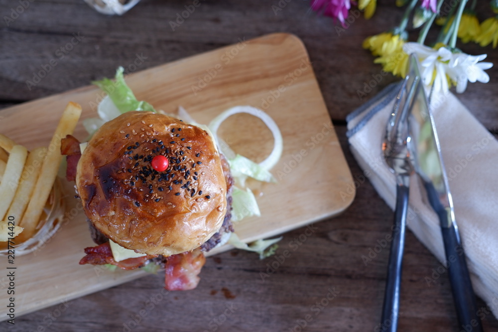 Sticker cheese burger on wood table