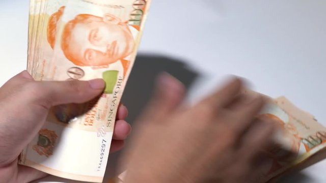 Counting Singapore currency 100 dollar bill SGD piece by piece note by note  Stock Video | Adobe Stock