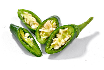 chopped green chili pepper close-up  on white background sprinkle with water
