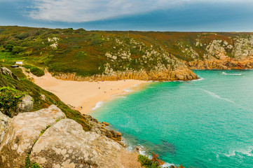 Panoramic photo of the idyllic Porthcurno beach in Cornwall, England.
