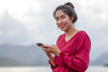 Naklejka premium young asian woman using smartphone