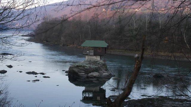 Unique Tiny House Built on a Rock on the River Drina in the Small Town of Bajina Basta, Serbia. Filmed During Morning Hours at Sunrise.