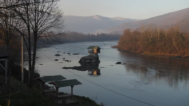 Unique Tiny Home Built on a Rock on the River Drina in the Small Town of Bajina Basta, Serbia. Filmed During Warm Morning Sunrise in Winter.