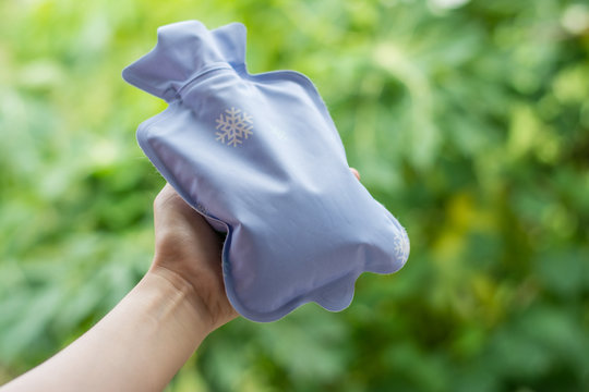 Close up woman has abdominal pain, woman's belly with hot water bottle,Close up woman use Hot Pack
