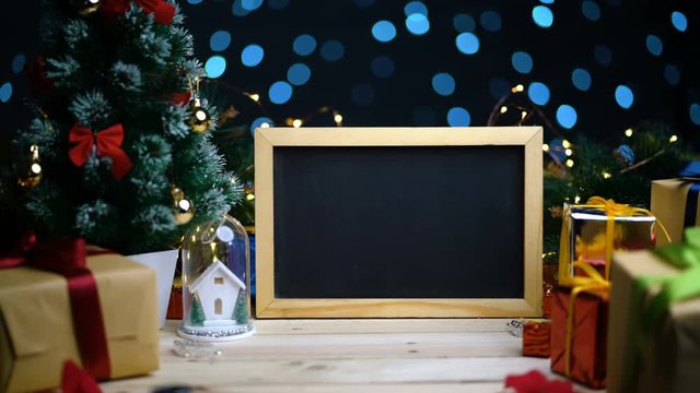 Dolly Shot of Empty Blackboard Between Christmas Decoration. With Tracking Marks and Alpha Channel Included. 4K