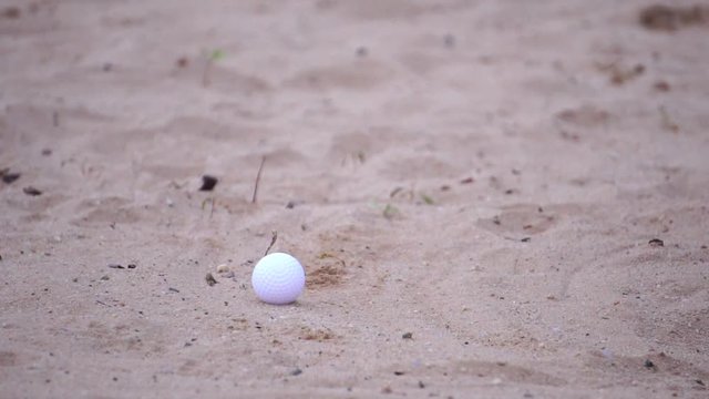 Golfers are hitting the golf ball on the bunker footage slow motion