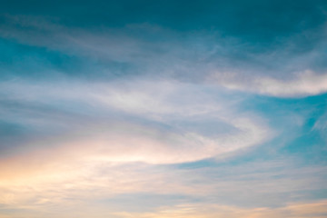 Sunset sky with curve cloud in blue and yellow color