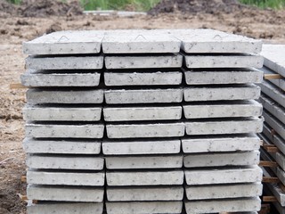 Prestressed Floor planks stacked for construction. It is a slab of reinforced concrete. Put together Structural Topping (concrete composite topping) will work in the same with the finished floor.