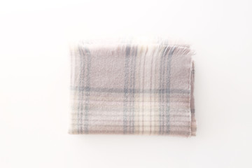 Winter warm feminine powder checkered scarf folded into a rectangle on a white background. Winter days concept. Women's fashion and accessories. Top view, flat lay