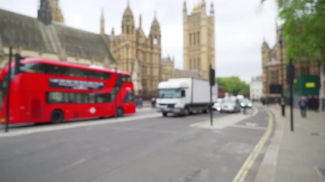 View of Victoria Tower from busy street in London, defocused background 
