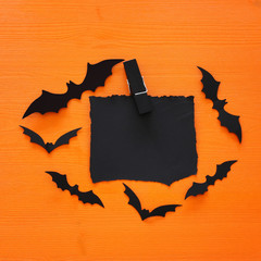 Halloween holiday minimal top view image of empty letter to add text over wooden background. Card and invitation concept.