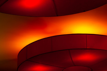 Interior ceiling red lights on dark background at night. Interior lighting concept. Red lights on ceiling. Architecture abstract background
