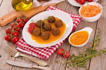 Meatballs with mashed carrots.