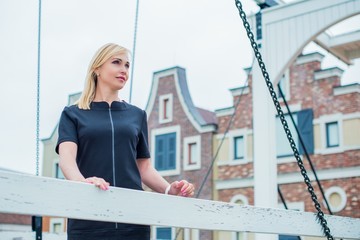 Portrait of attractive mature woman in casual style walk at city at autumn day and thinking about something. Life of women after 35- 40 years 