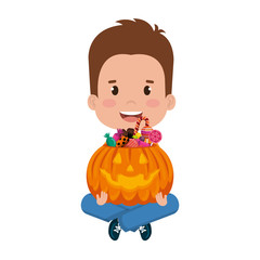 little boy lifting halloween pumpkin with candies