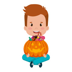 little boy lifting halloween pumpkin with candies