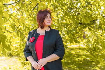Happy smiling beautiful plus size model . Close up large girl smiling on a sunny day with good...