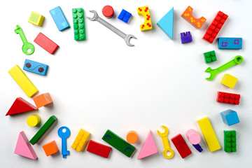 Baby toys frame. Colorful kids toys on white background. Copy space for text. Top view. Flat lay.