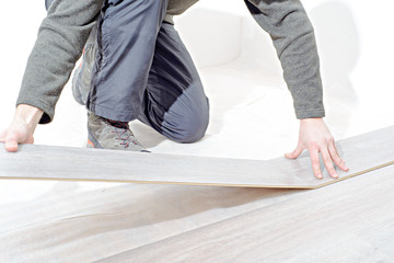  installing new laminated wooden floor. copy space