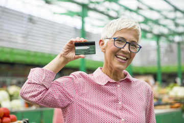 Senior woman holds credit card