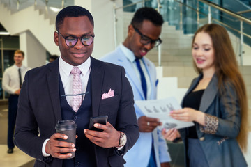Portrait of ambitious business team diverse ethnicity multinational people in stylish suit getting communicating together in lobby of modern the office .