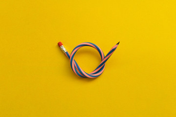 Flexible pencil . Isolated on yellow background