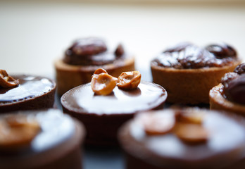 Delicious chocolate cakes with nuts on plate in cafe