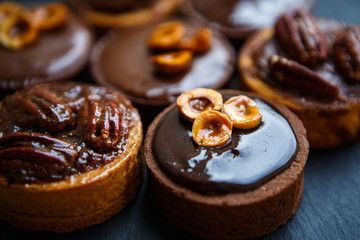 Delicious chocolate cakes with nuts on plate in cafe