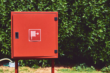 red street hydrant mounted on a green lawn