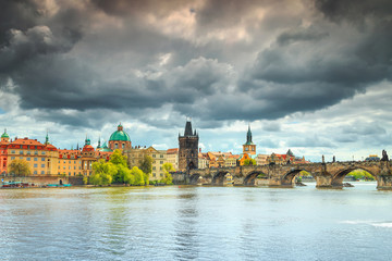 Magical cloudy sky and colorful buildings in Prague, Czech Republic