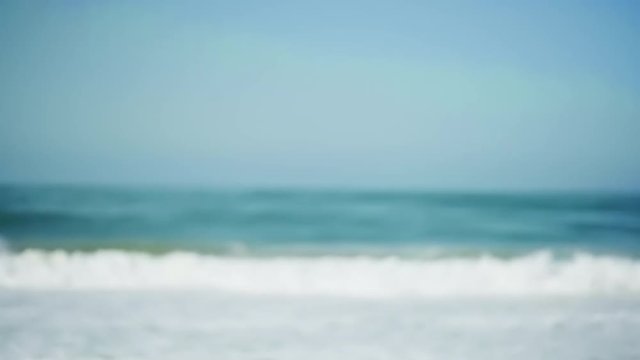 Very out of focus large waves crashing on the beach for green screen