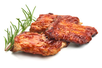 Delicious spicy marinated ribs in a bbq or tomato sauce with herbs, isolated on a white background. Close-up.