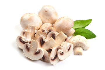 Sliced champignons with basil leaves, close-up, isolated on white background.