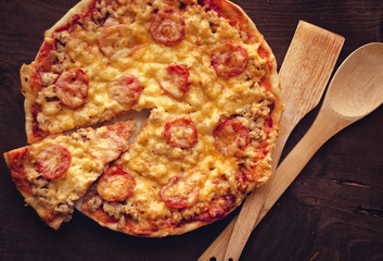 Homemade spicy pizza. Pizza with slice cut.