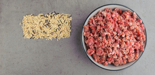 Natural raw ingredients for pet food on grey background. Flat lay.