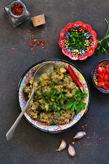 Sauteed eggplant. Salad of baked eggplants on a dark background.
