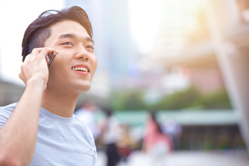 young smart asian male teen calling phone call communication with other