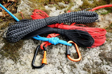 Metal carabine and rope . Photo of colored carabines. Climbing concept