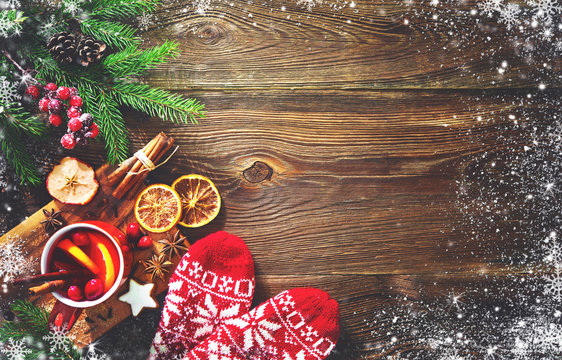 Christmas mulled red wine with spices and fruits on a wooden rustic table