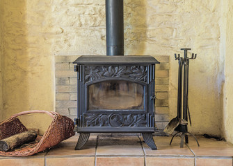 Beautiful wood stove with fireplace set tools in the stones home