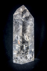 Close up shot of cut white quartz stone on dark surface.