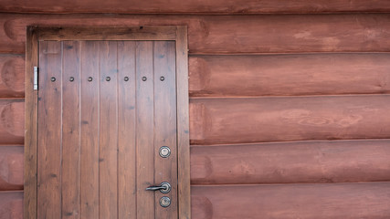 Log house wood wall with closed door