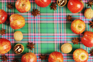 A background with autumn mood formed with apples with free space for text in the center