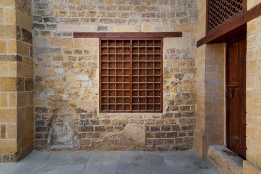 Mamluk era wooden closed window with wooden ornate grid over stone bricks wall, Tekkeyet Al Bustami, Dar El Labana district, Cairo, Egypt