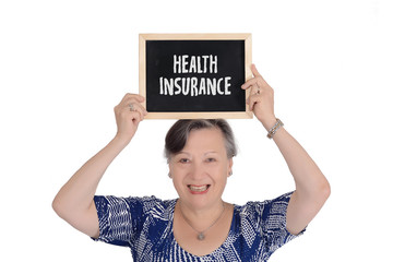 Elderly woman holding chalkboard with text "health insurance"