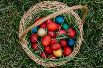 Easter eggs in a basket on grass