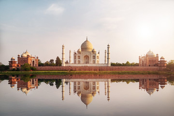 Sun set at Taj Mahal seen from Mehtab Bagh reflect on Yamuna river, an ivory-white marble mausoleum...