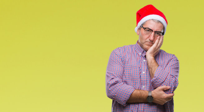 Handsome Senior Man Wearing Christmas Hat Over Isolated Background Thinking Looking Tired And Bored With Depression Problems With Crossed Arms.