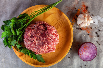  set of fresh ingredients  for cooking ground beef:beef meat, onion, garlic, tomato, spices, salt, pepper, greenery. The process of cooking meatballs, hamburger, lasagna and other meat dishes